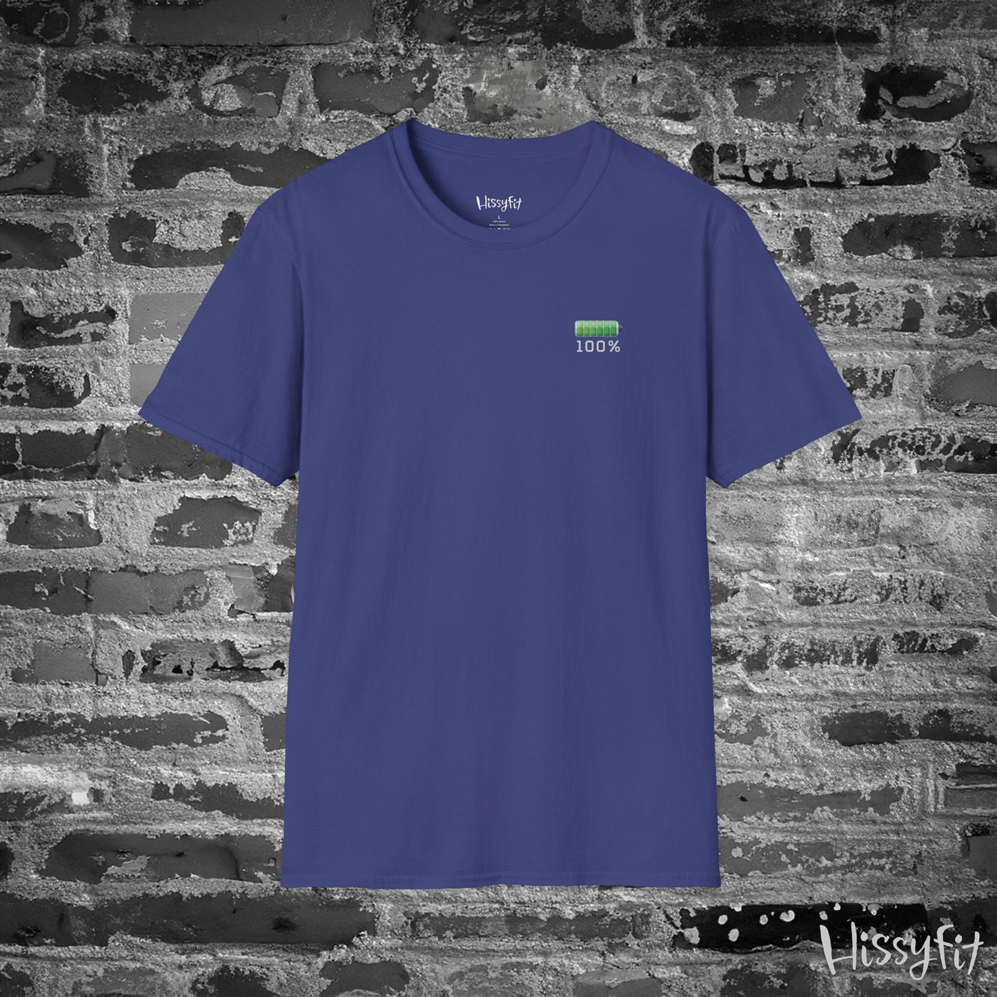 Blue t-shirt with a green battery symbol displaying '100 percent charged' on a brick wall background
