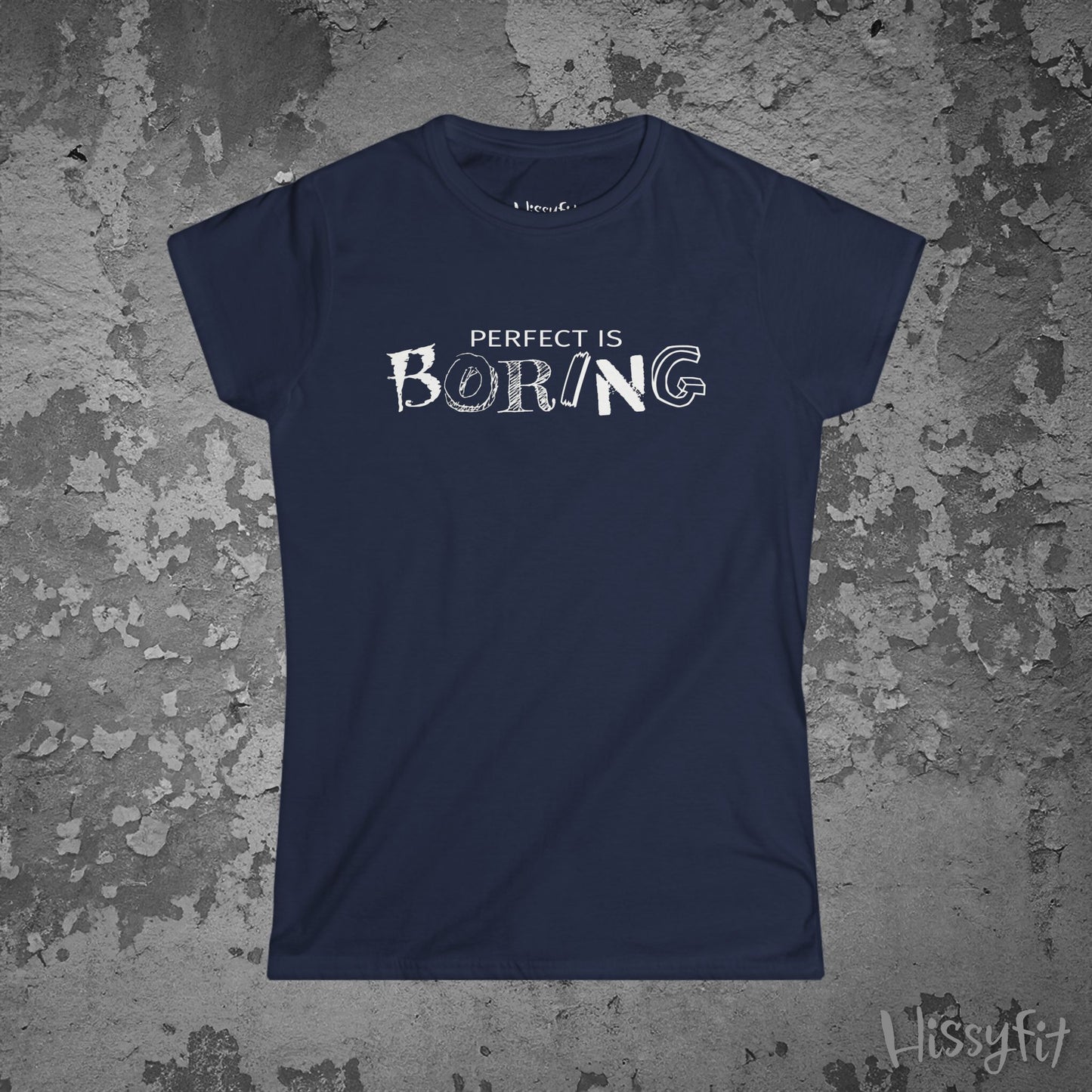 Navy blue t-shirt with 'PERFECT IS BORING' text on a textured gray background