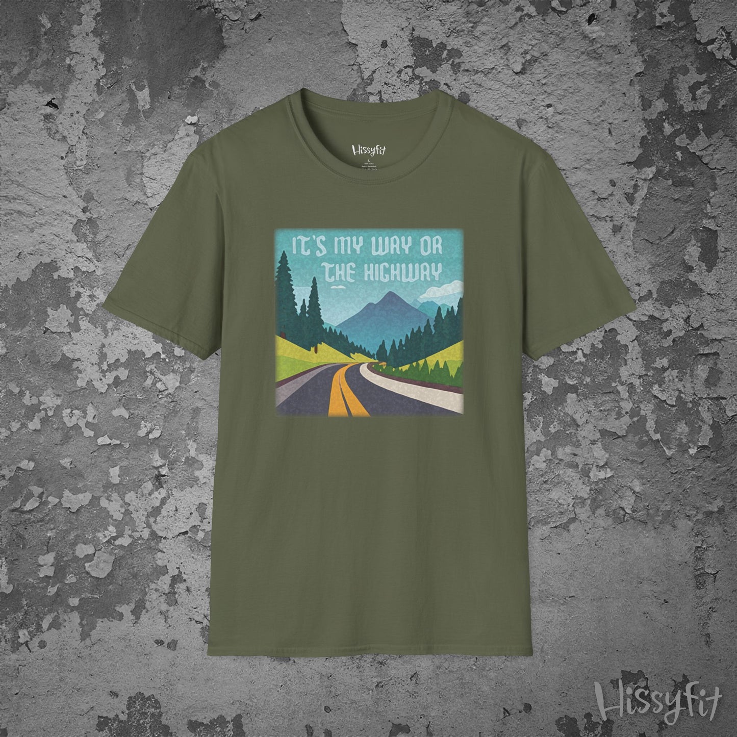 Green t-shirt with a graphic design of a road and mountains and text 'It's my way or the highway' on a textured gray background