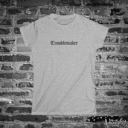 Gray t-shirt with 'Troublemaker' text on a brick wall background