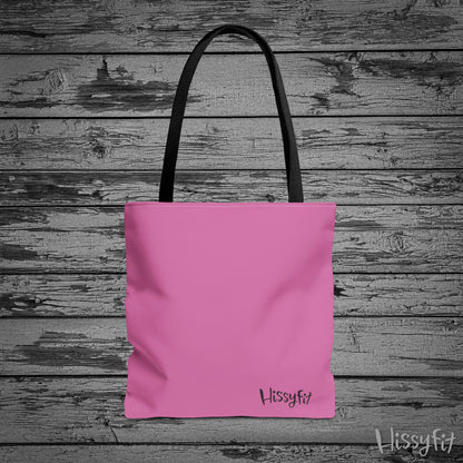 Pink tote bag with 'Hissyfit' branding on a wooden background