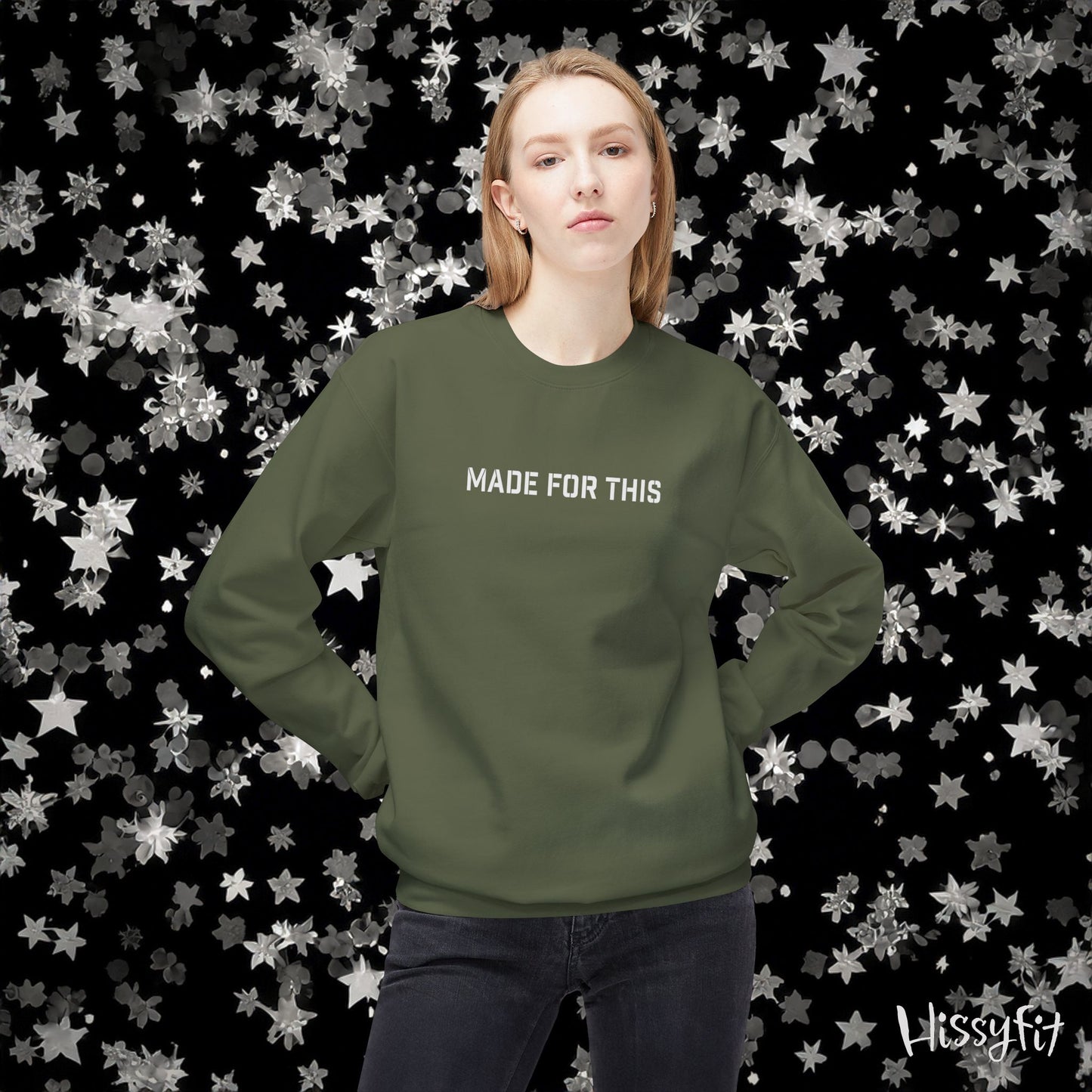 Person wearing a green sweatshirt with 'MADE FOR THIS' text against a star-patterned background