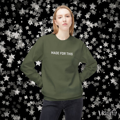 Person wearing a green sweatshirt with 'MADE FOR THIS' text against a star-patterned background