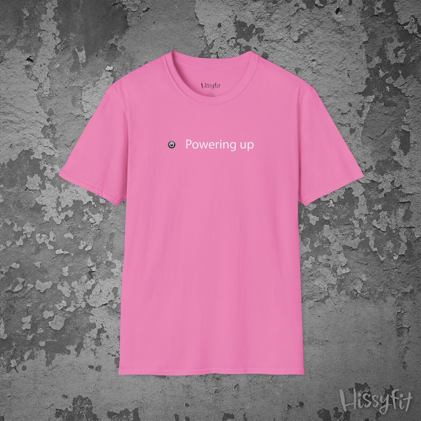 Pink t-shirt with 'Powering up' text on a textured gray background