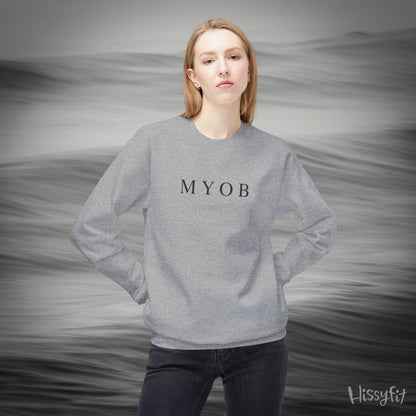 Person wearing a gray sweatshirt with 'MYOB' text against a gray background