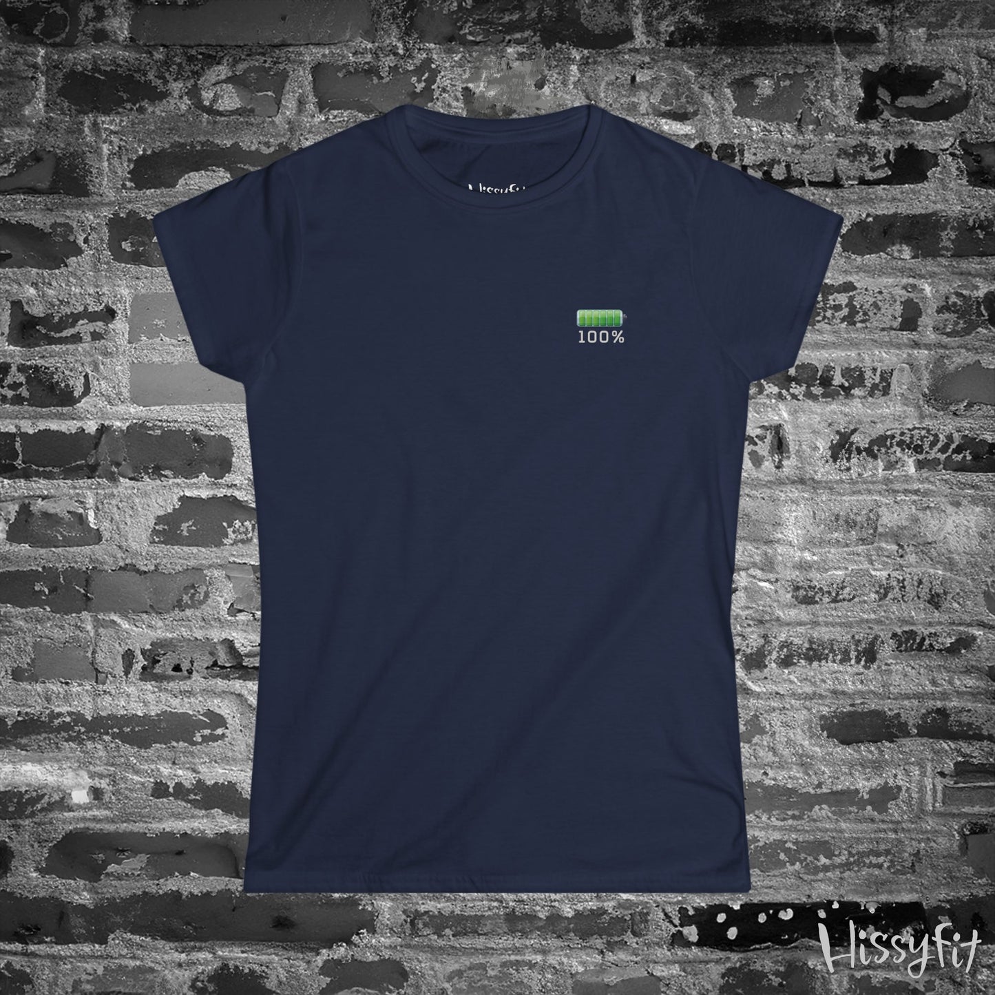 Navy blue t-shirt with a green battery icon and '100%' text on a brick wall background