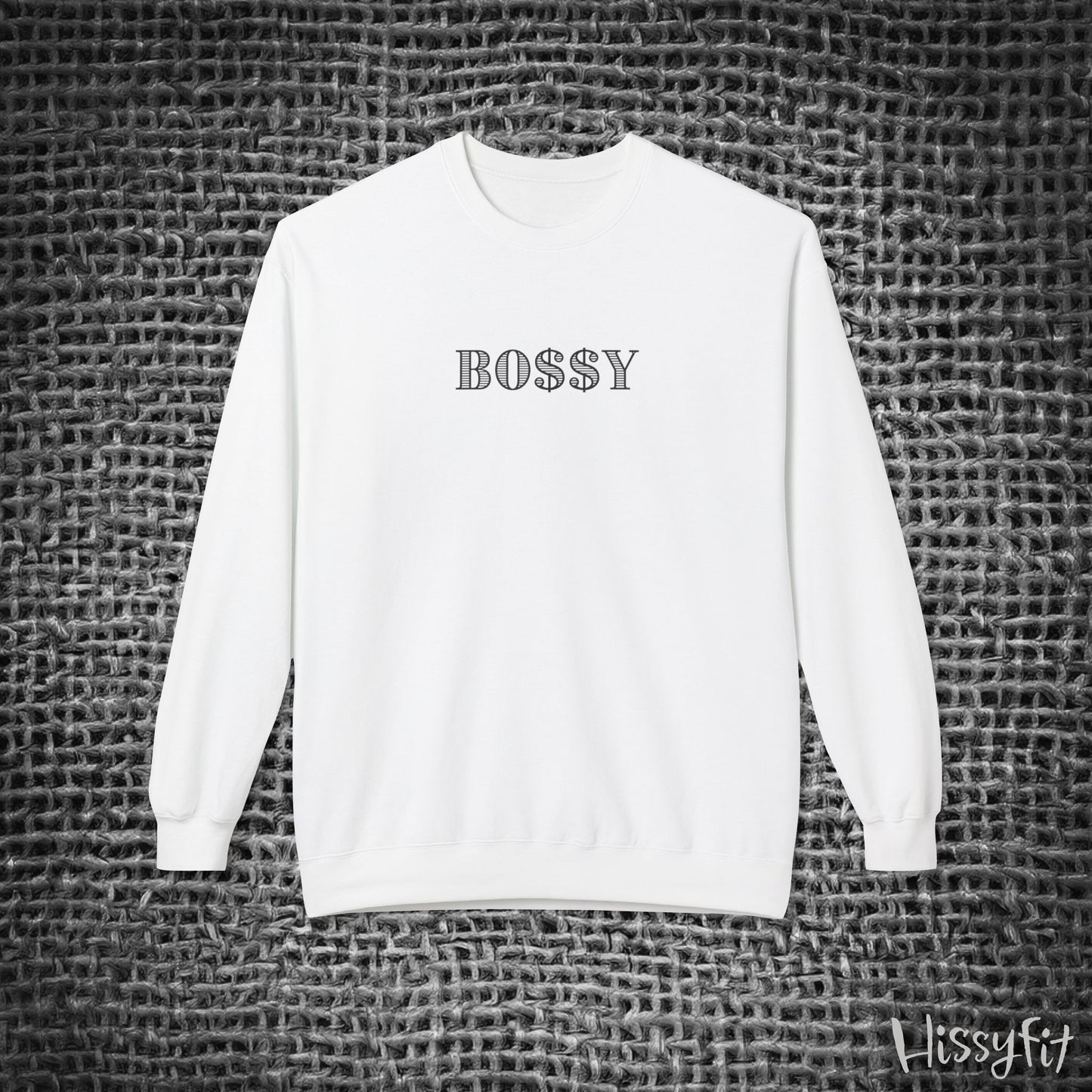 White sweatshirt with 'BOSSY' text on a textured gray background