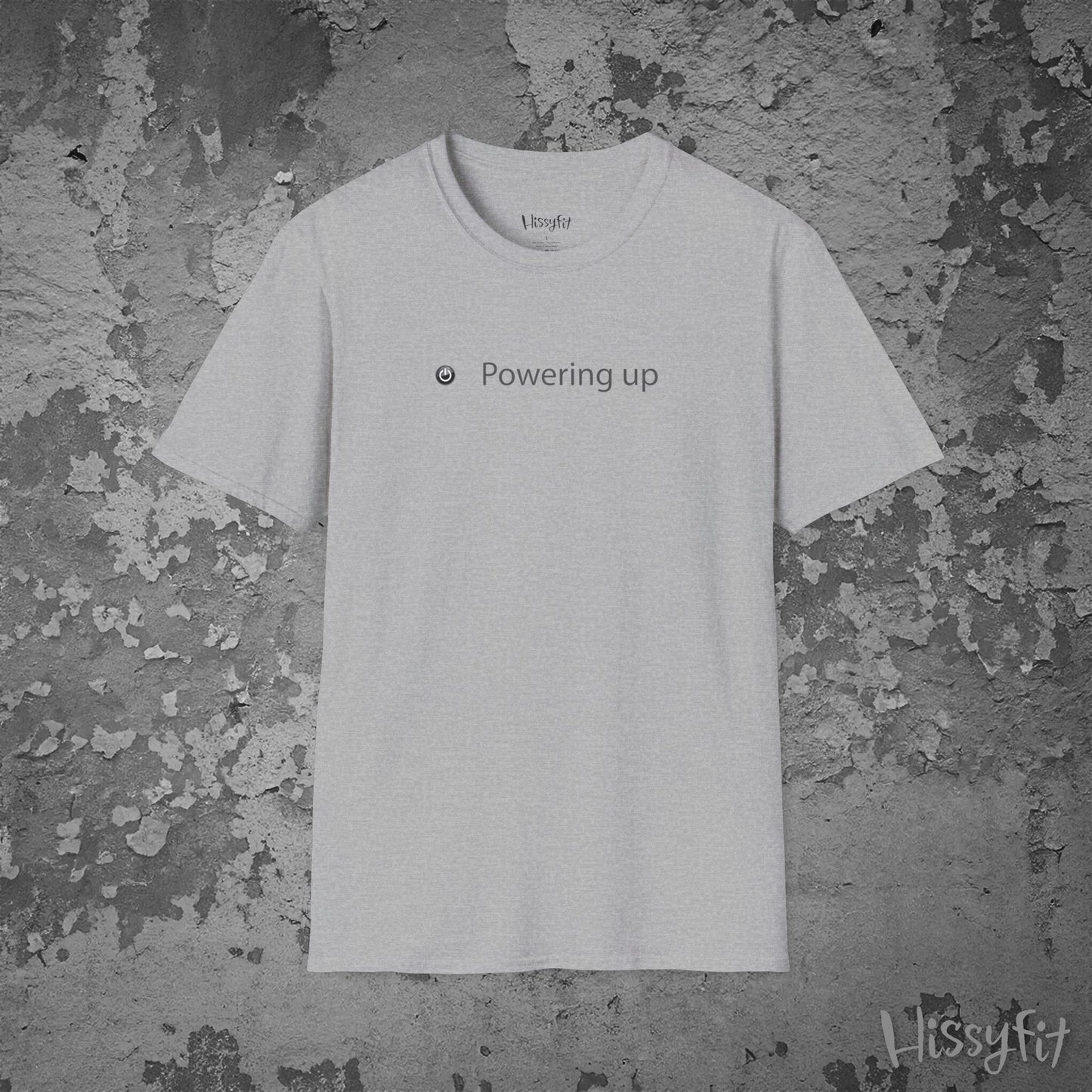 White t-shirt with 'Powering up' text on a textured gray background