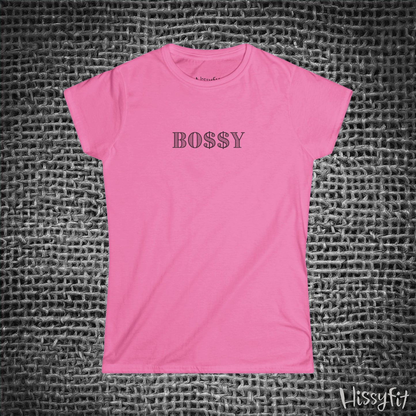 Pink t-shirt with 'BOSSY' text on a textured gray background