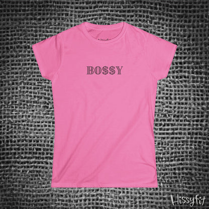 Pink t-shirt with 'BOSSY' text on a textured gray background