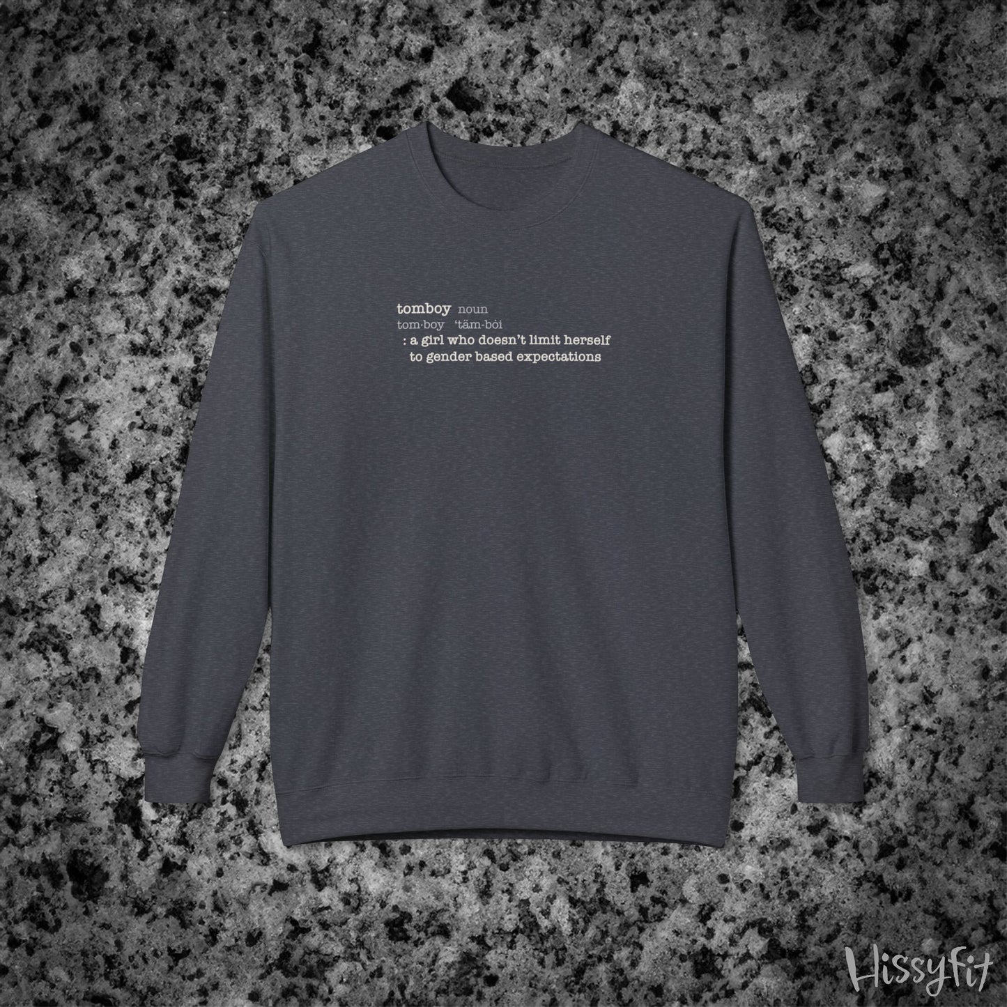 Gray sweatshirt with text definition of "Tomboy" on a gray and black speckled background