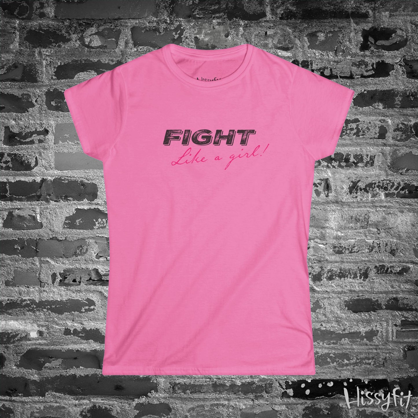 Pink t-shirt with 'Fight Like a Girl' text on a brick wall background