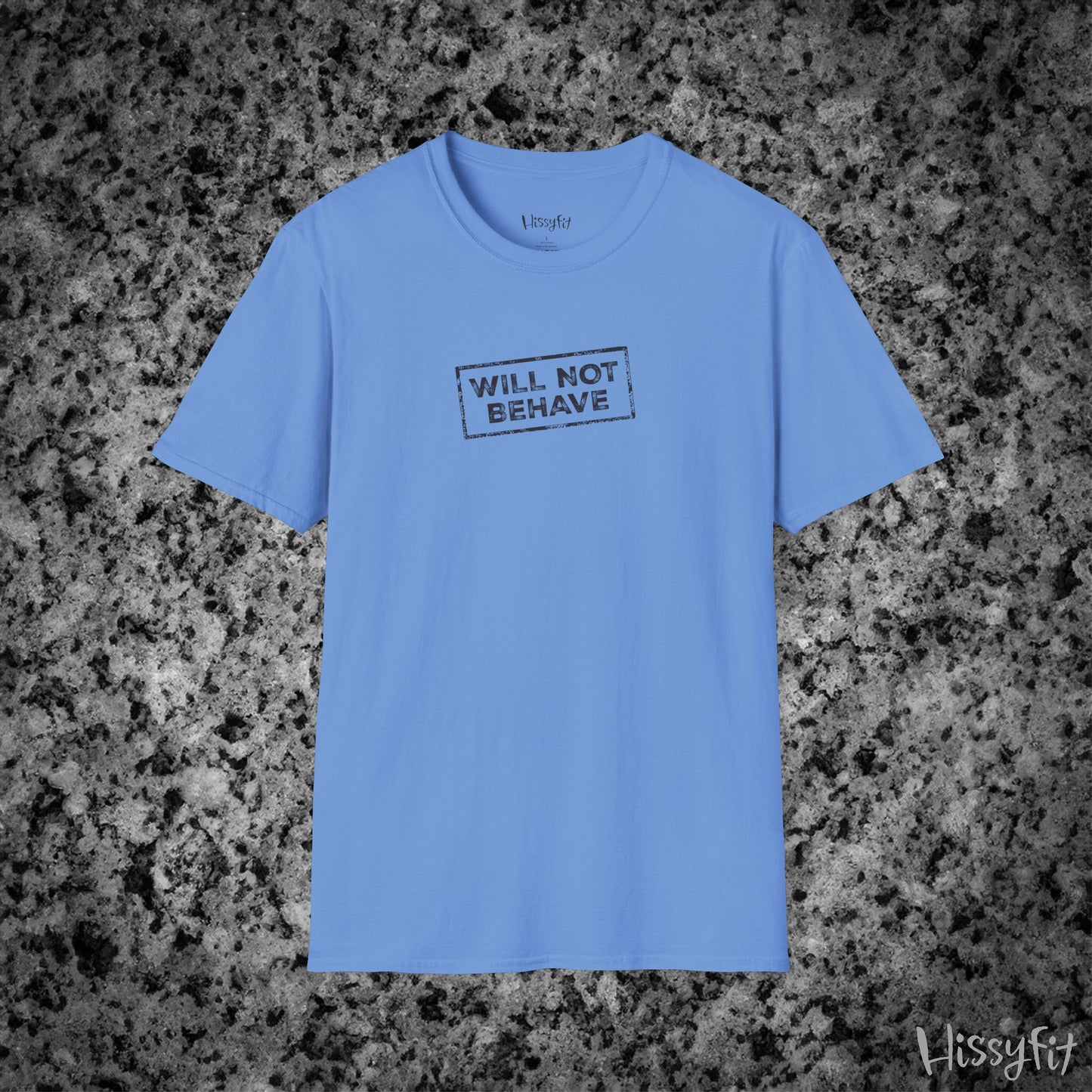 Blue t-shirt with 'WILL NOT BEHAVE' text on a textured gray background