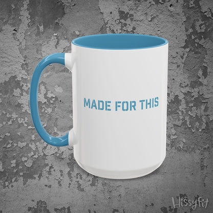 White mug with blue interior and handle on a textured gray background, featuring 'MADE FOR THIS' text.