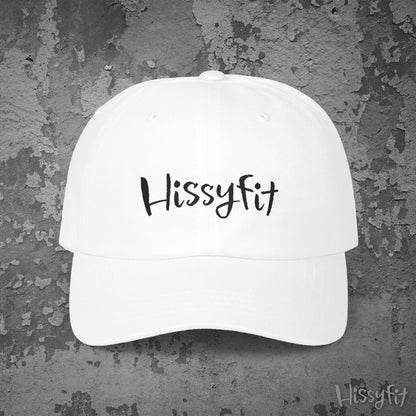 White cap with 'Hissyfit' text on a textured gray background