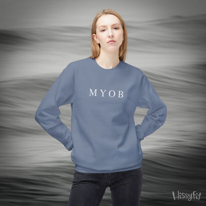 Person wearing a blue sweatshirt with 'MYOB' text against a gray background
