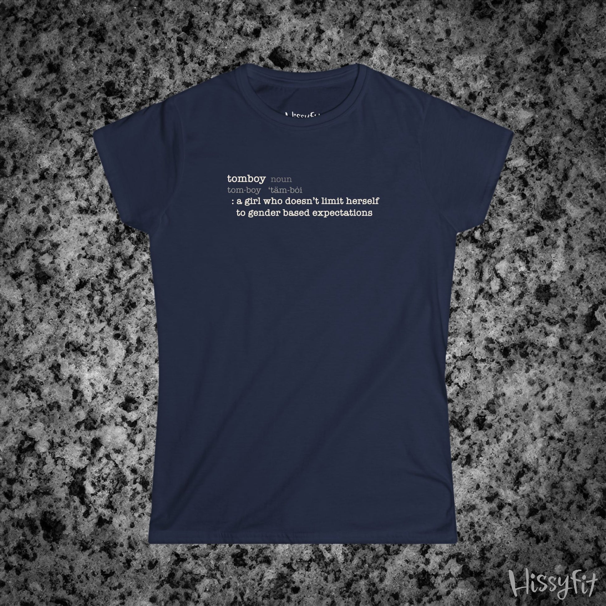 Navy blue t-shirt with text 'Tomboy:definition' on a gray granite surface, featuring the brand 'Hissyfit'.