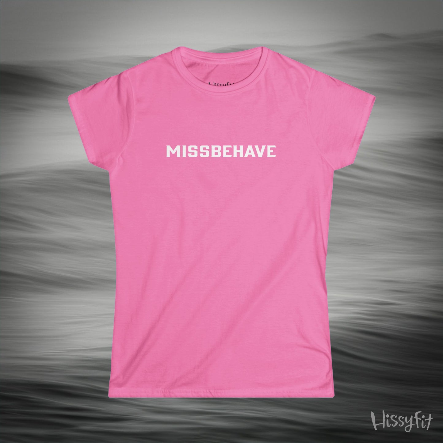 Pink t-shirt with 'MISSBEHAVE' text on a gray background