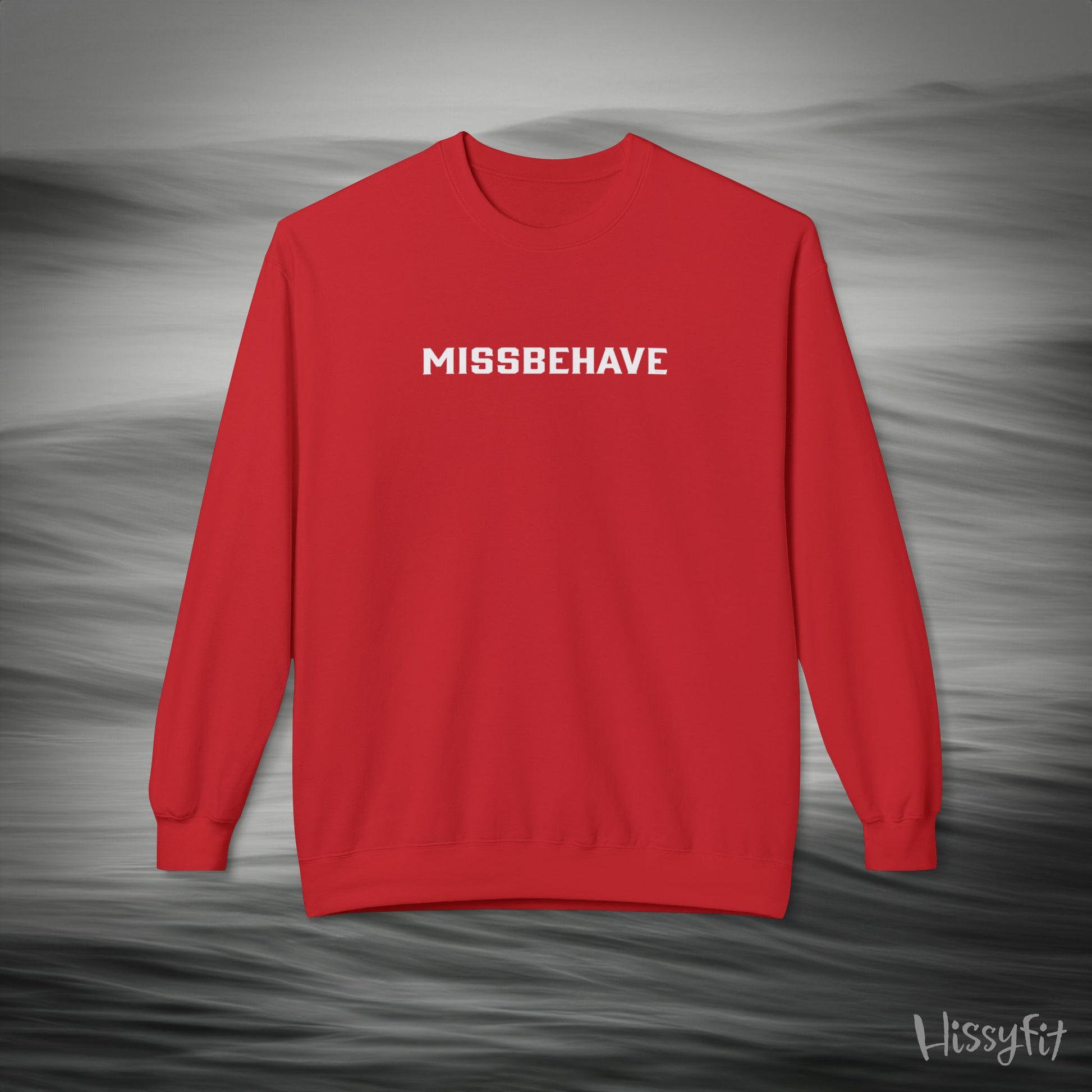 Red sweatshirt with 'MISSBEHAVE' text on a gray background