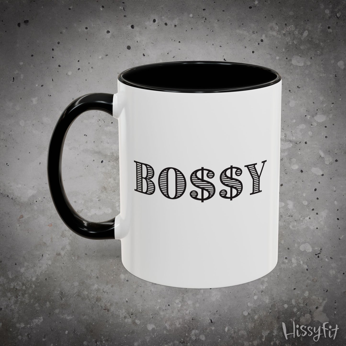 White mug with black handle and 'BOSSY' text on a gray background