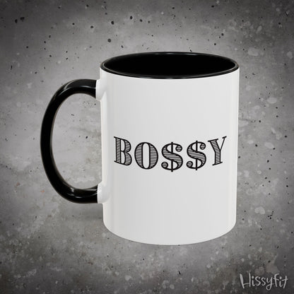 White mug with black handle and 'BOSSY' text on a gray background