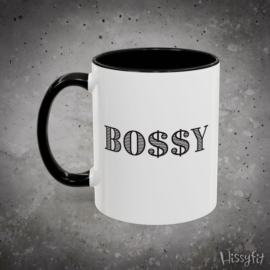 White mug with black handle and 'BOSSY' text on a gray background