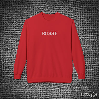 Red sweatshirt with 'BOSSY' text on a textured gray background