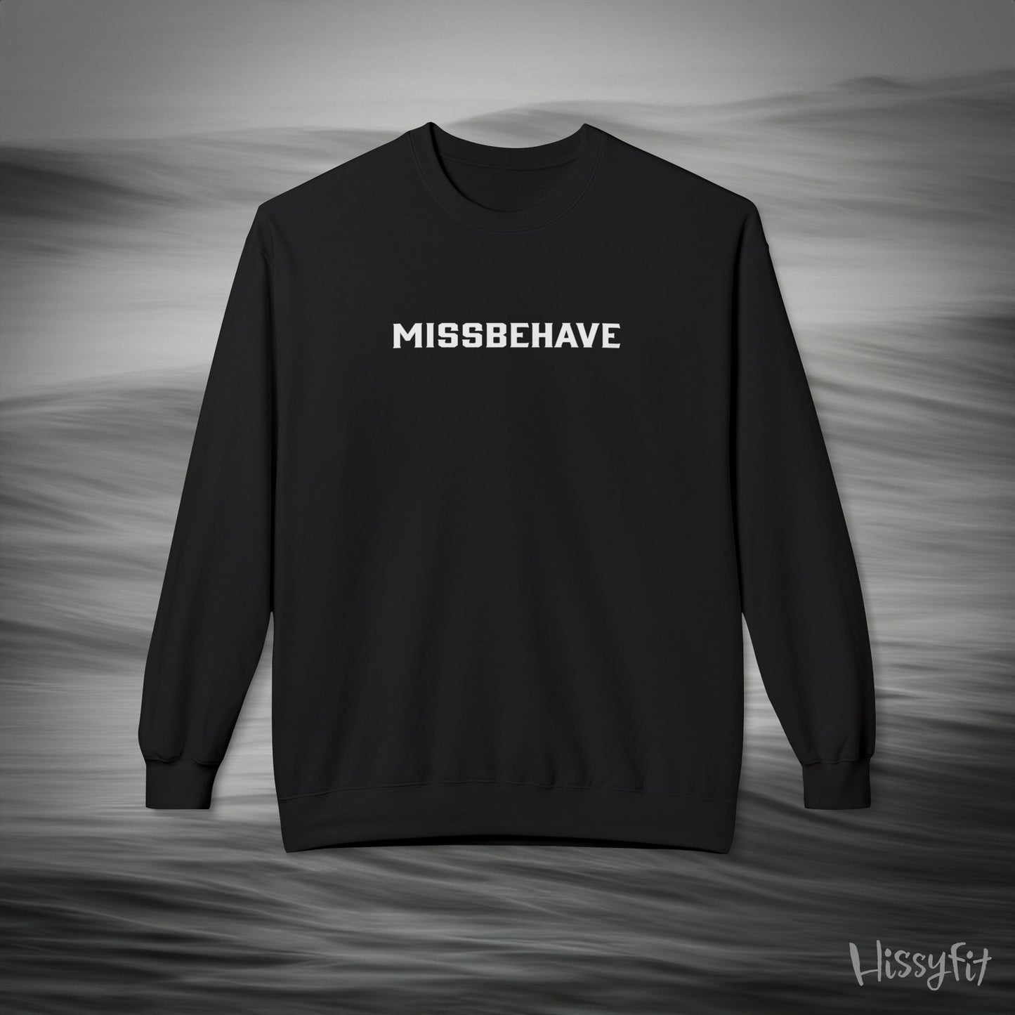 Black sweatshirt with 'MISSBEHAVE' text on a gray background