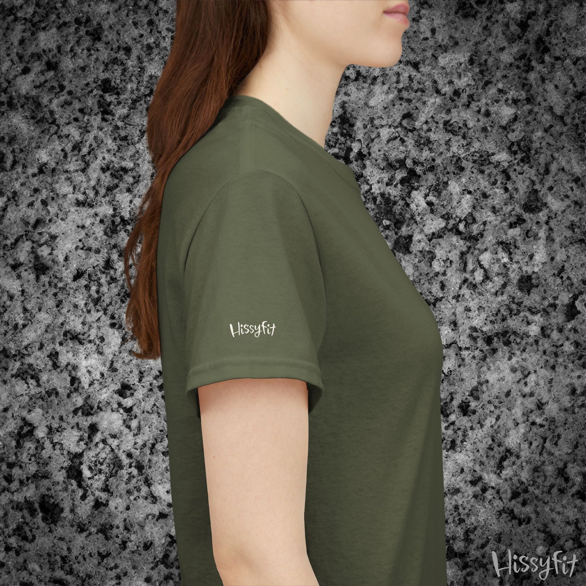 Person wearing a green t-shirt with 'Hissyfit' logo against a gray granite background