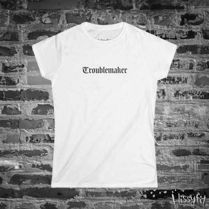 White t-shirt with 'Troublemaker' text on a brick wall background