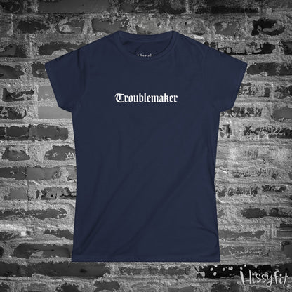 Navy blue t-shirt with 'Troublemaker' text on a brick wall background