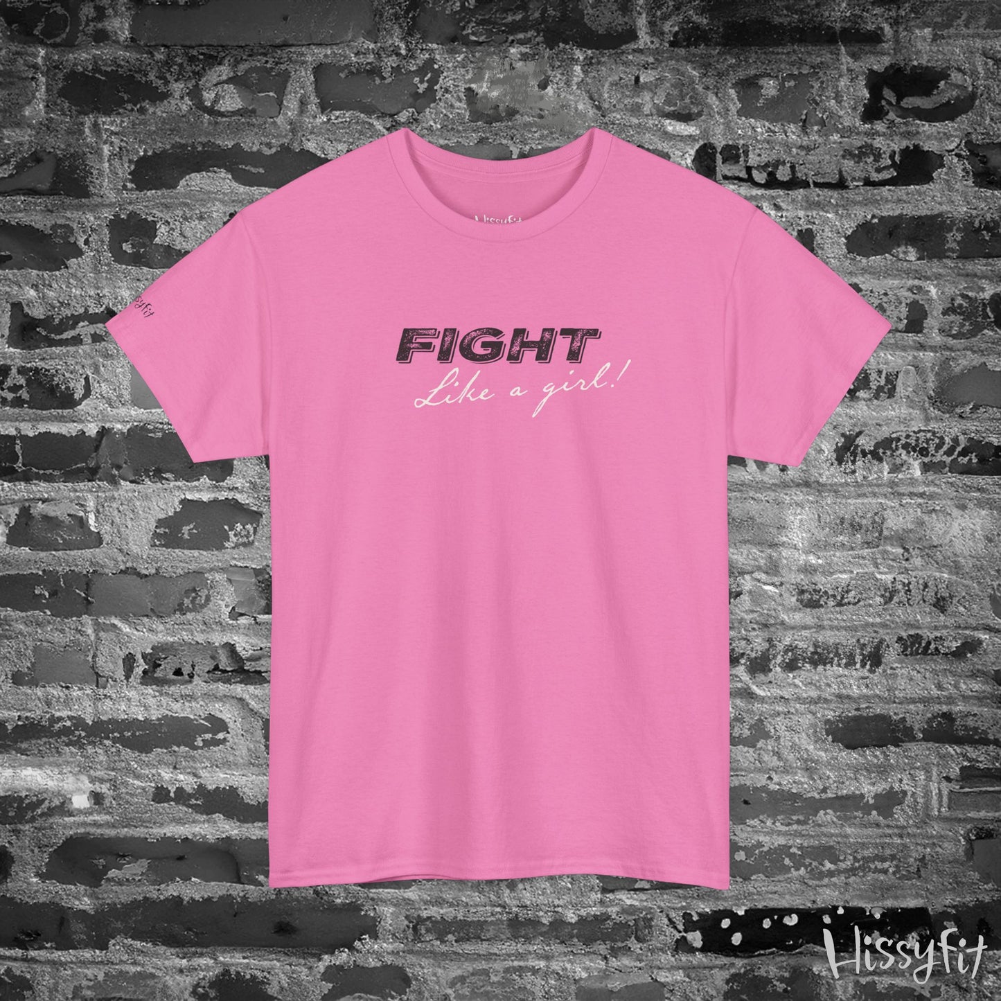 Pink t-shirt with 'Fight Like a Girl' text on a brick wall background