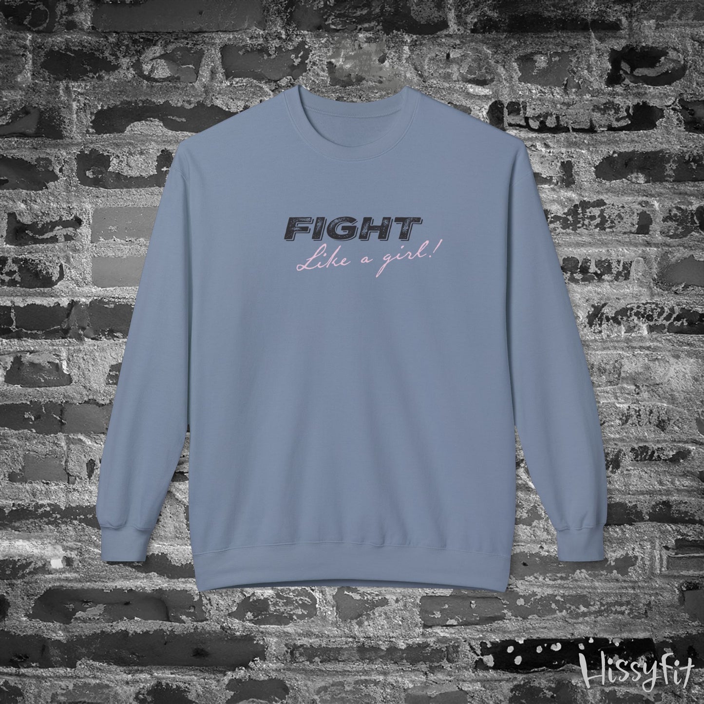 Blue sweatshirt with 'Fight Like a Girl' text on a brick wall background