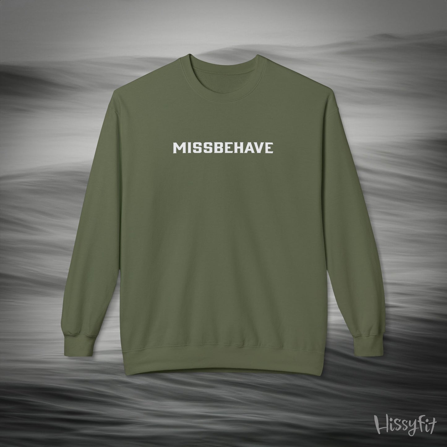 Green sweatshirt with 'MISSBEHAVE' text on a gray background