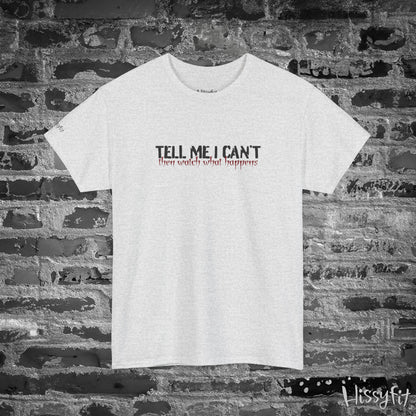White t-shirt with text 'Tell me I can't then watch what happens' on a brick wall background