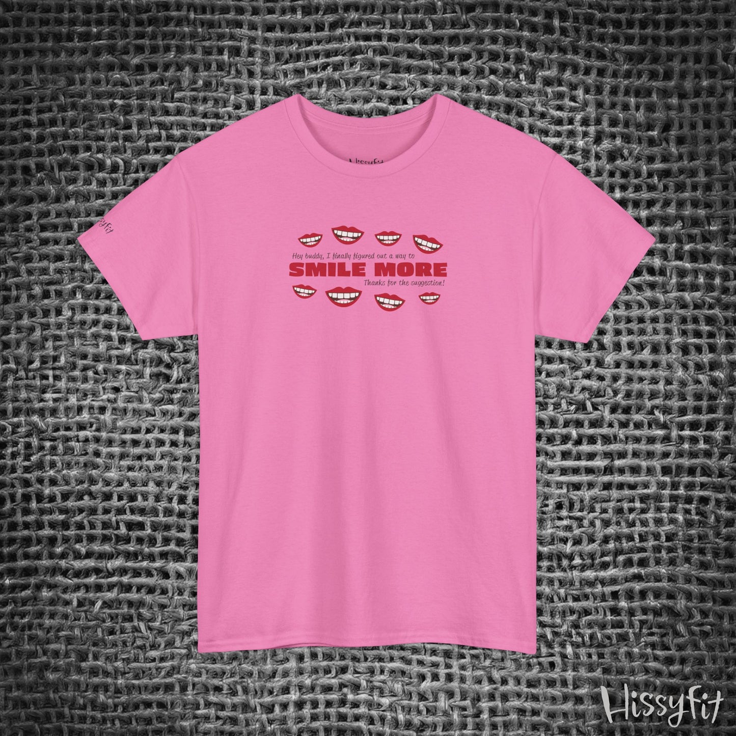 Pink t-shirt with text 'Smile more' and smiley faces on a textured gray background