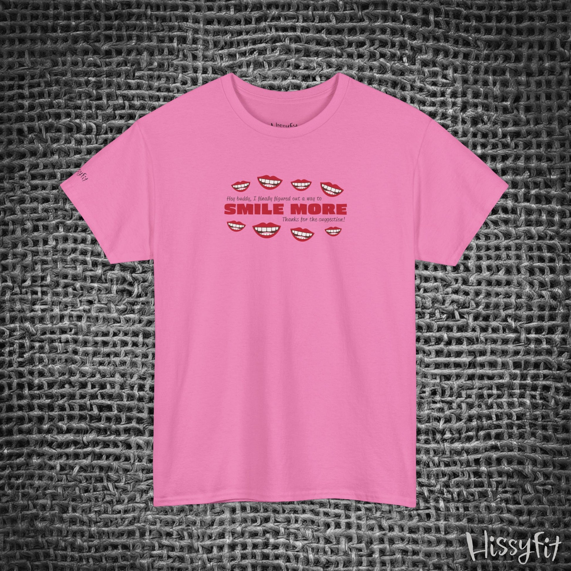 Pink t-shirt with text 'Smile more' and smiley faces on a textured gray background