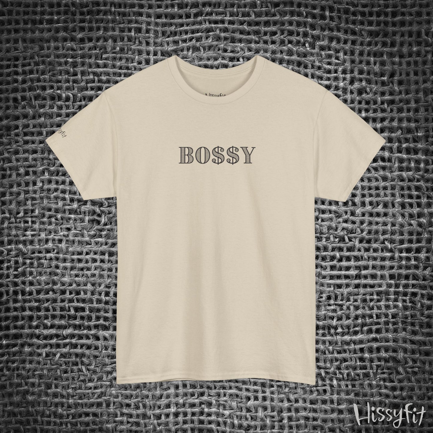 Beige t-shirt with 'BOSSY' text on a textured gray background