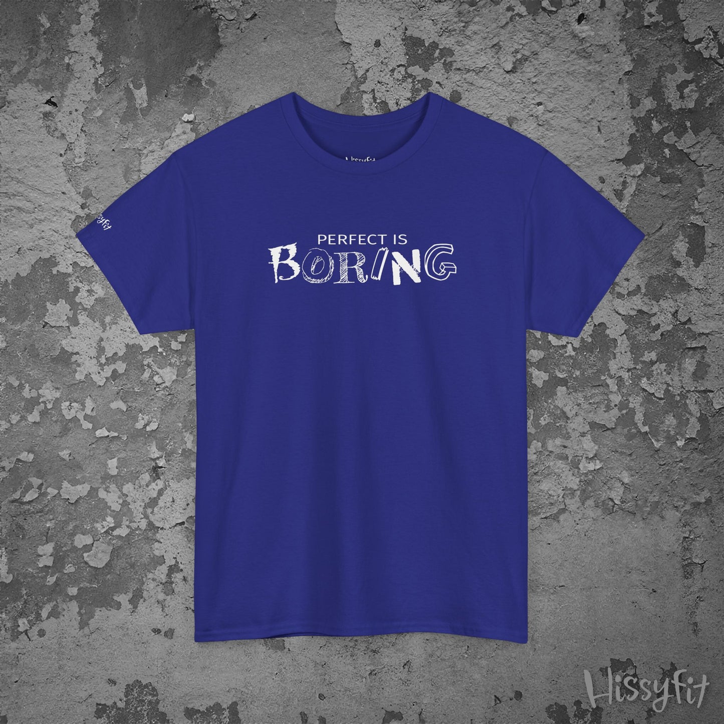 Blue t-shirt with 'PERFECT IS BORING' text on a textured gray background