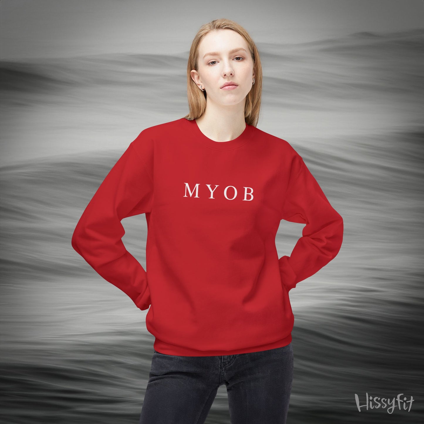 Person wearing a red sweatshirt with 'MYOB' text against a gray background