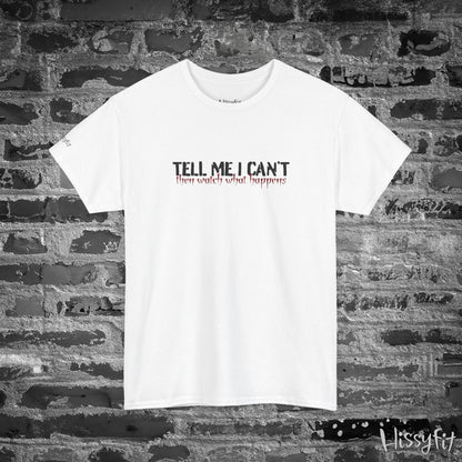 White t-shirt with text 'Tell me I can't then watch what happens' on a brick wall background