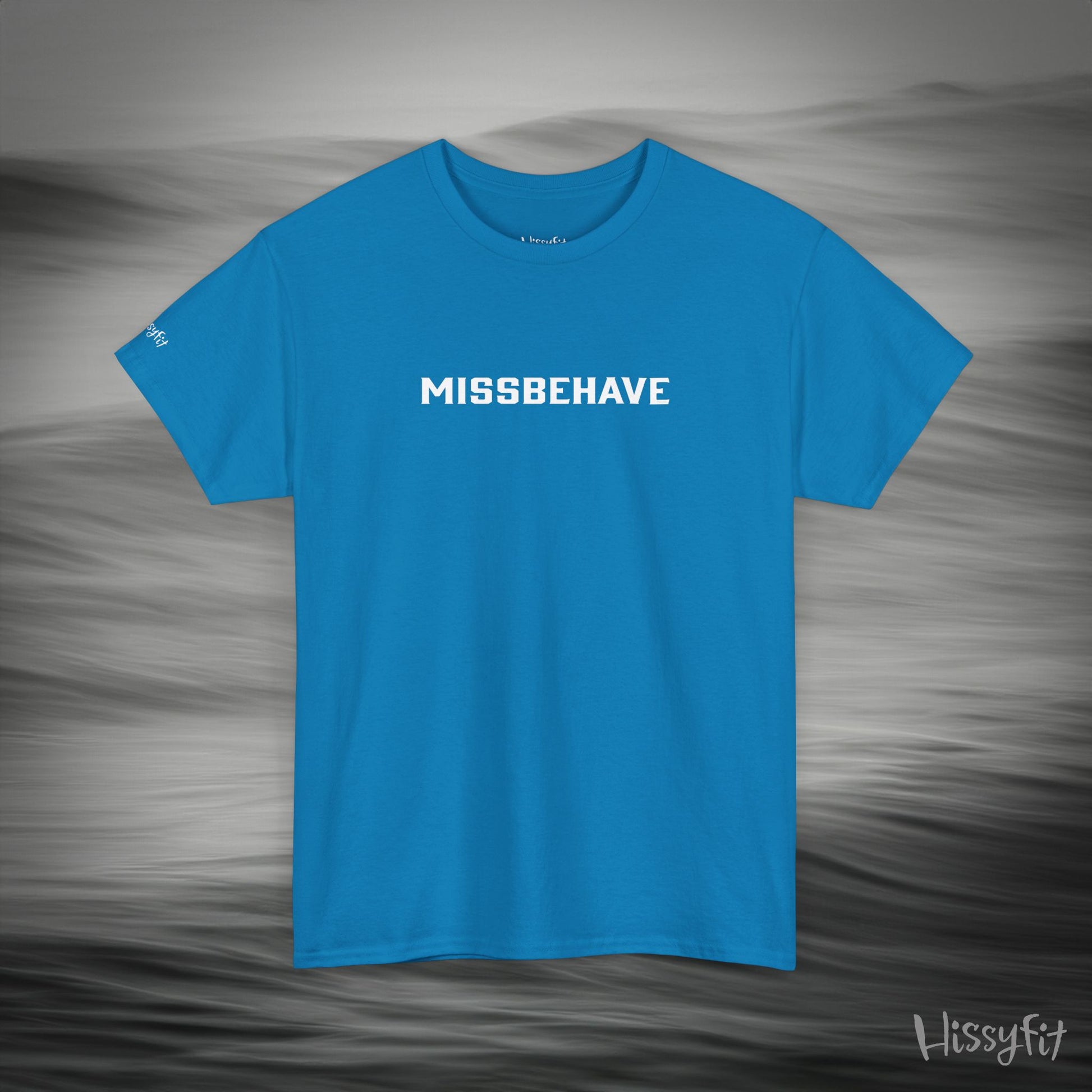 Blue t-shirt with 'MISSBEHAVE' text on a gray background