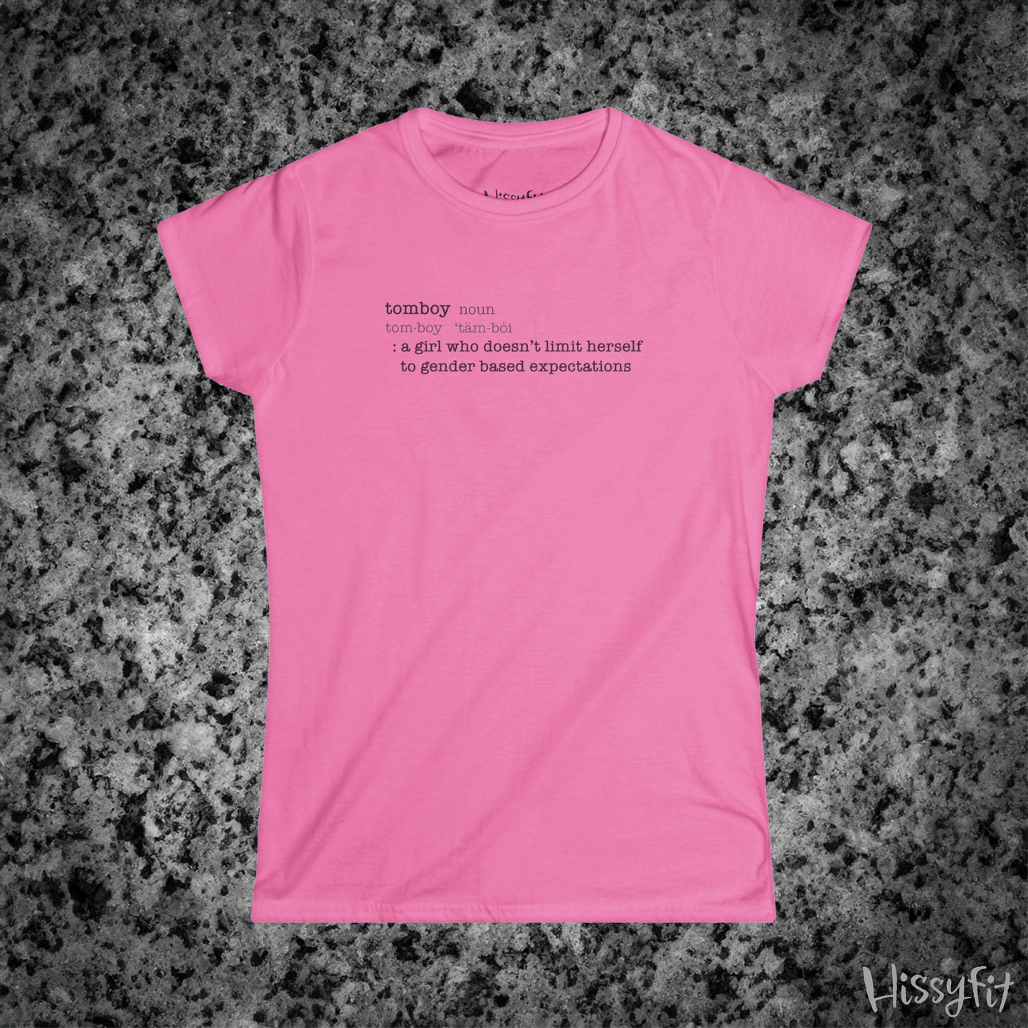 Pink t-shirt with text 'Tomboy:definition' on a gray granite surface, featuring the brand 'Hissyfit'.
