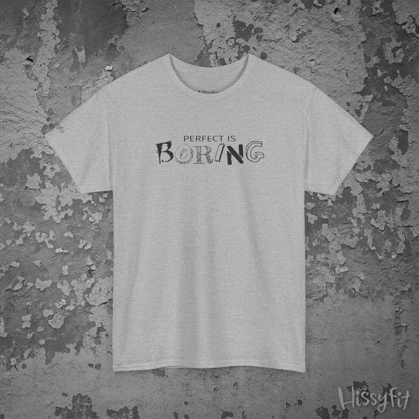Gray t-shirt with 'Perfect is Boring' text on a textured gray background