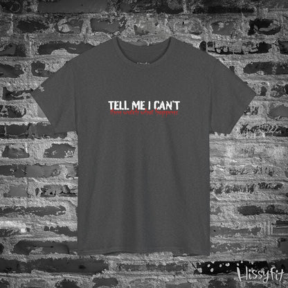 Black t-shirt with 'Tell Me I Can't then watch what happens' text on a brick wall background