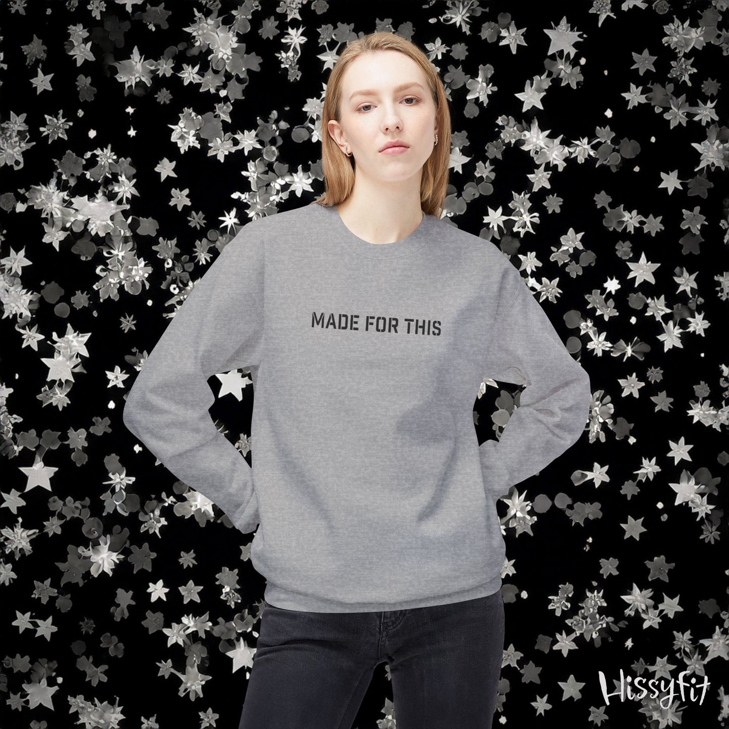 Person wearing a gray sweatshirt with 'MADE FOR THIS' text against a star-patterned background
