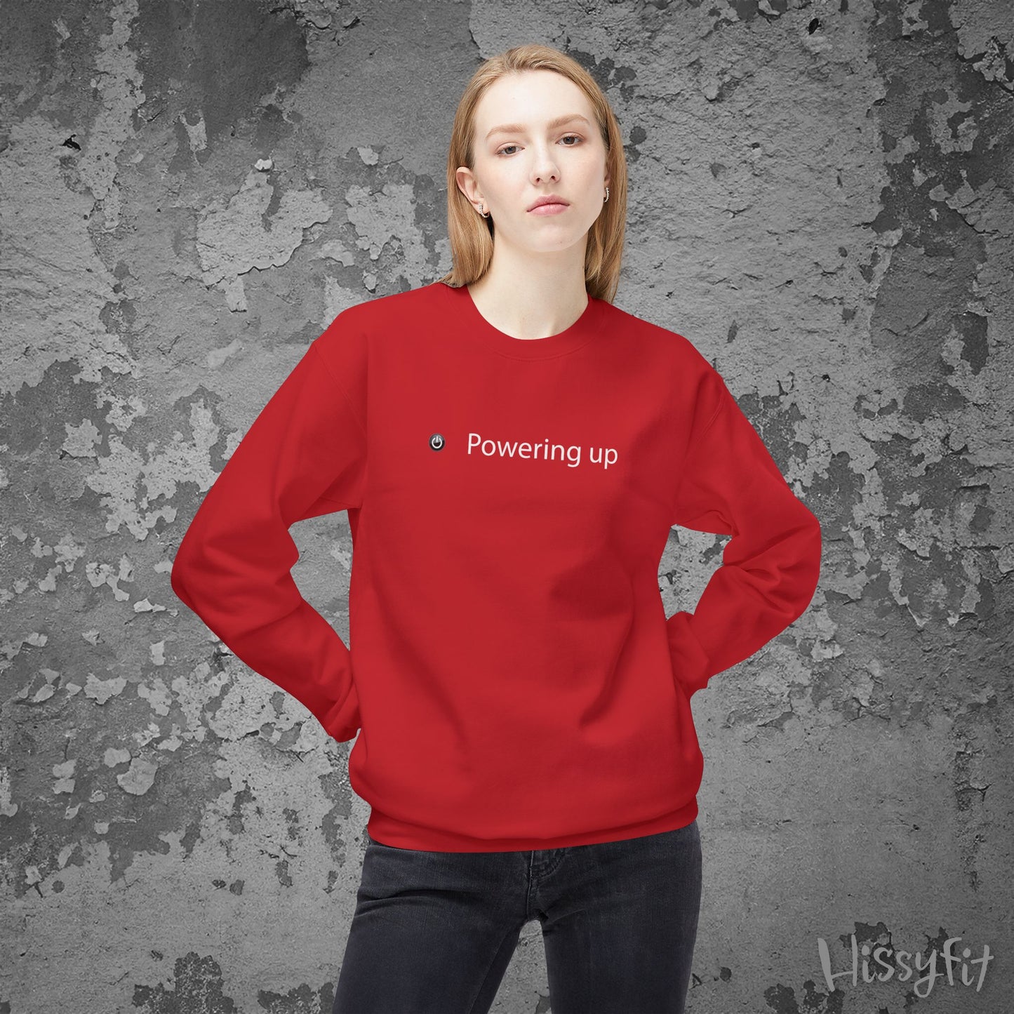 Person wearing a red sweatshirt with 'Powering up' text against a textured gray background