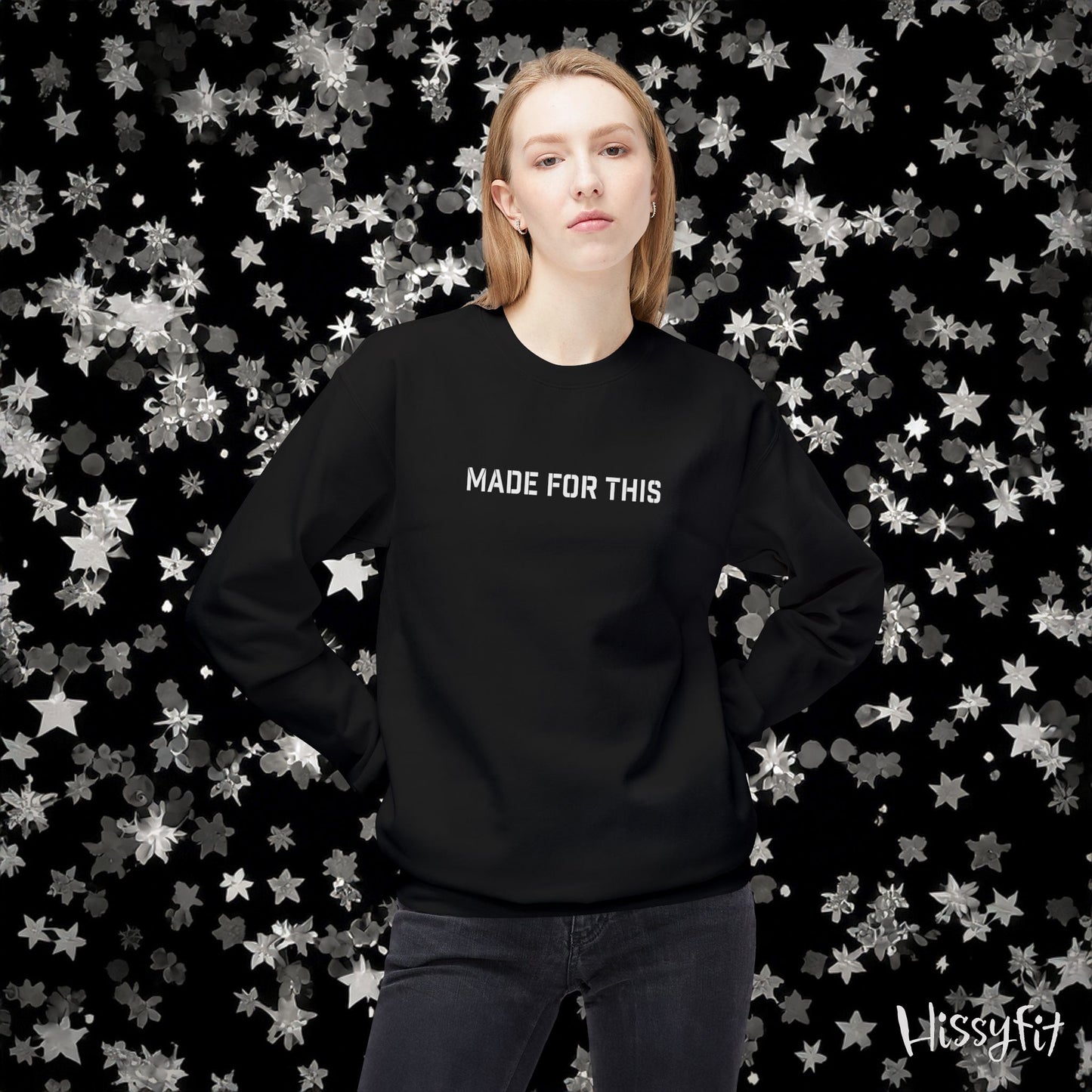Person wearing a black sweatshirt with 'MADE FOR THIS' text against a star-patterned background