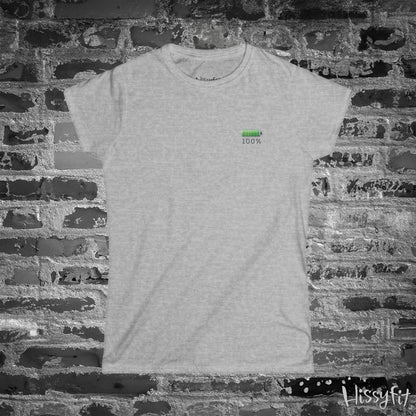 Gray t-shirt with a green battery symbol and '100%' charged on a brick wall background
