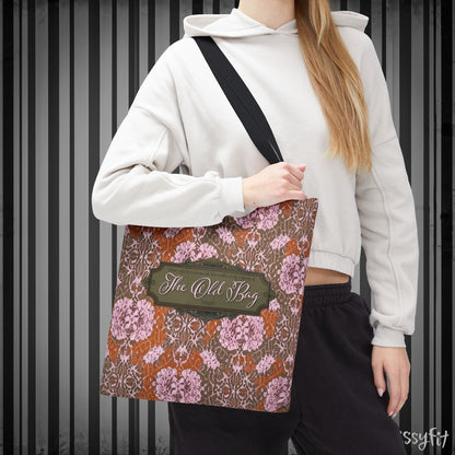 Person wearing a floral-patterned bag with 'The Old Bag' label against a striped background